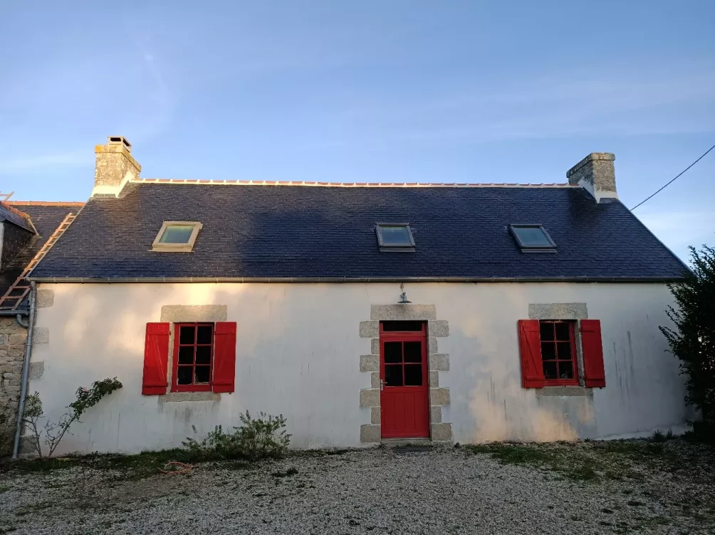 Maison avec toit en ardoise, fenêtre de toit en place.
